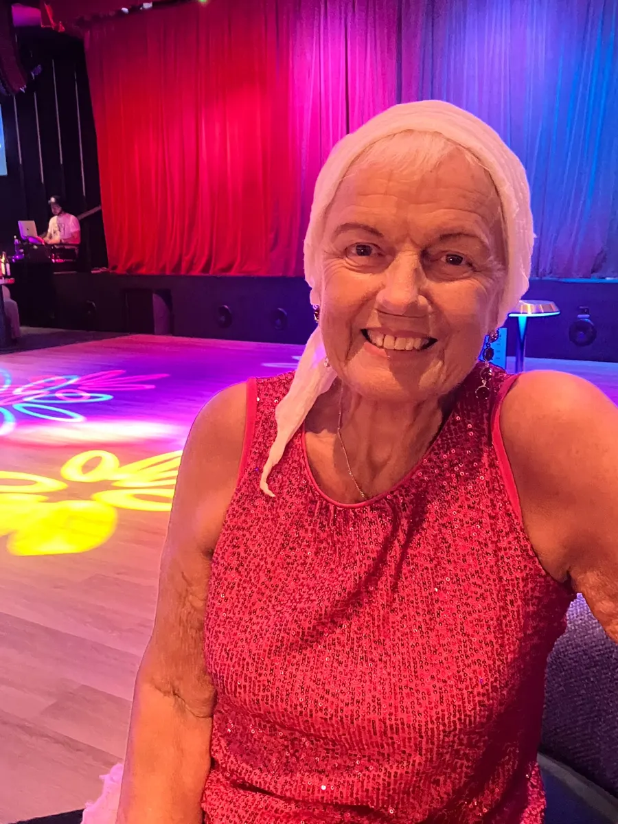 Linda smiling in front of a theatre stage