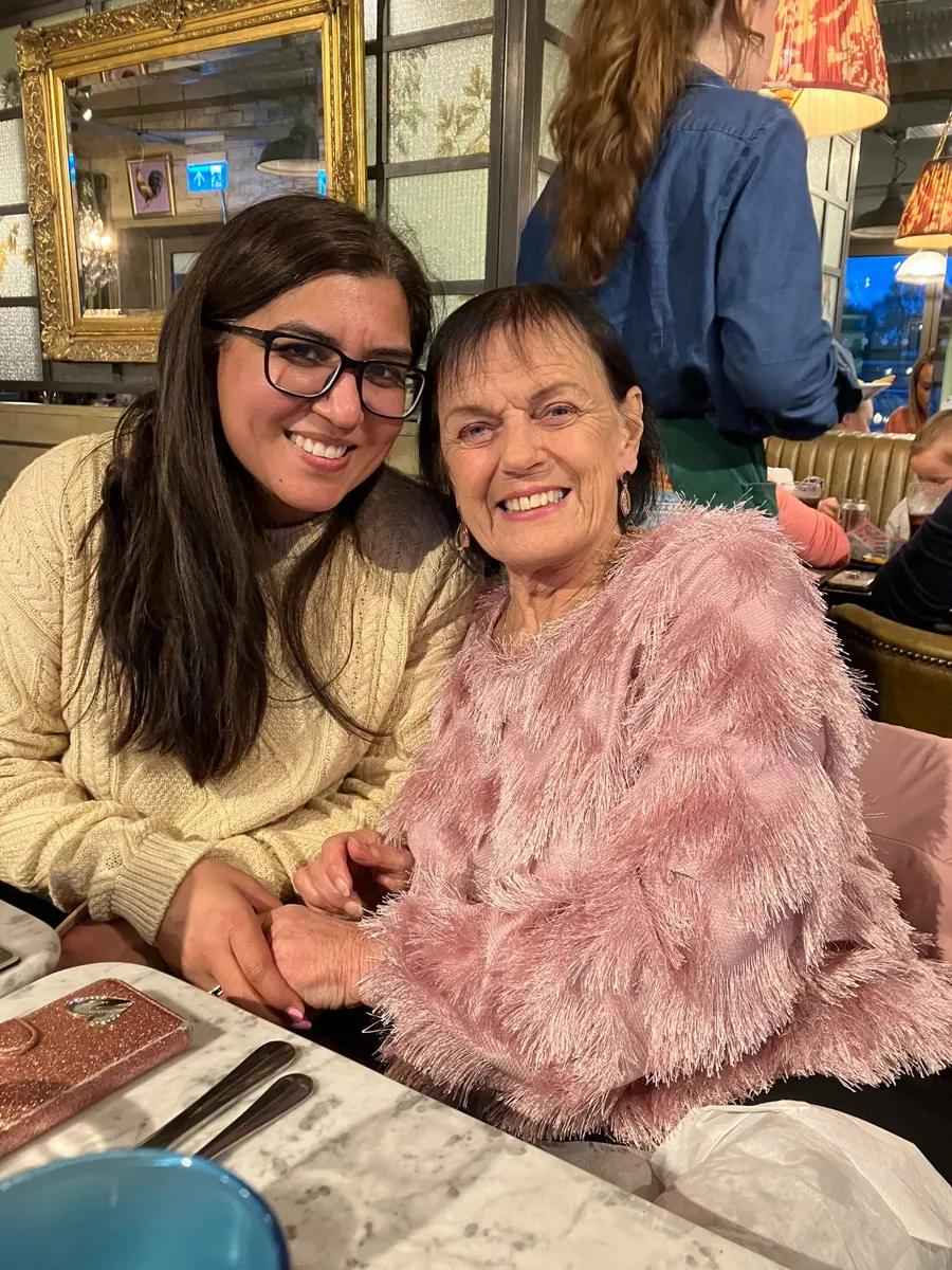 Linda with a friend at a restaurant table