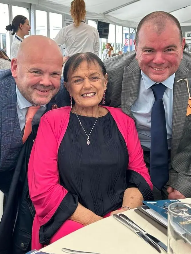 Linda with two friends at a dinner