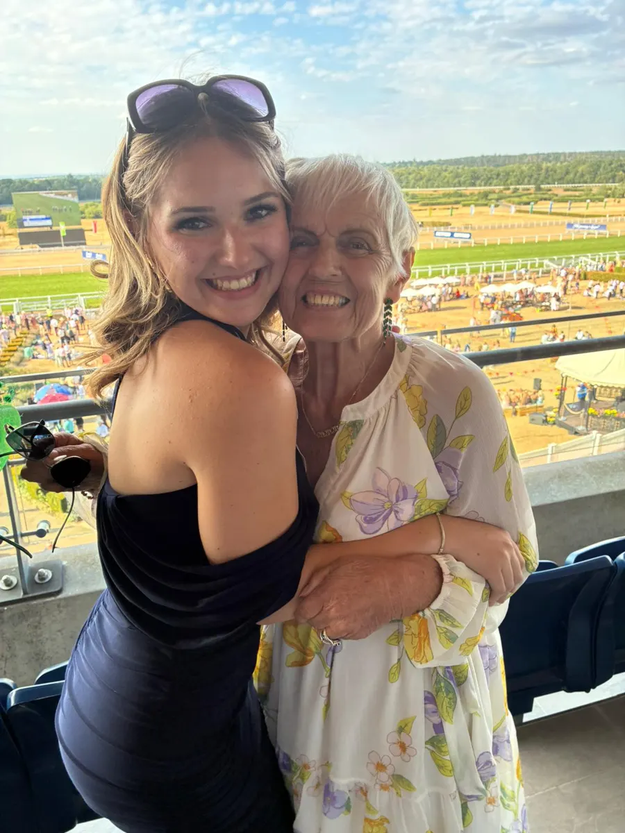 Two guests share a hug at Ascot